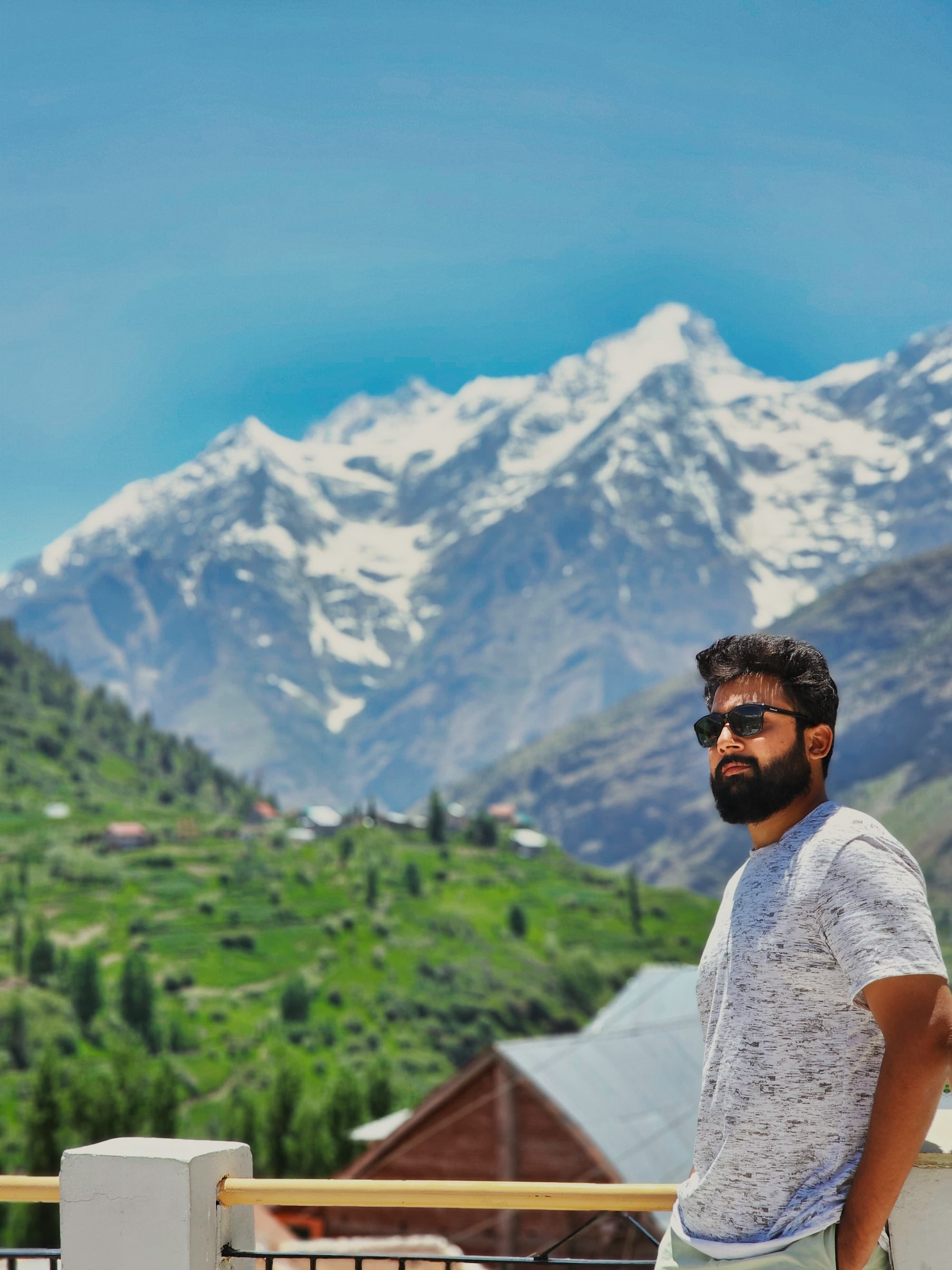 Abhishek Yadav in the mountains of Himachal, snow peaks behind him